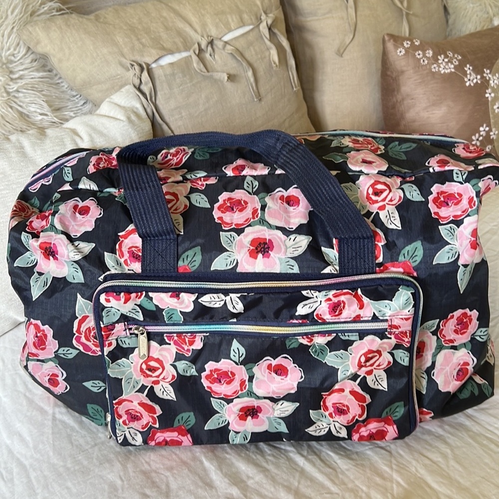 Large- foldable- travel duffel bag. Blue floral pattern with rainbow zipper.